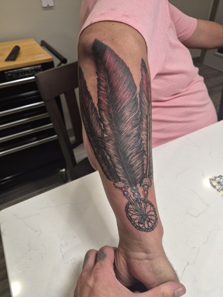 Feather tattoo on the forearm