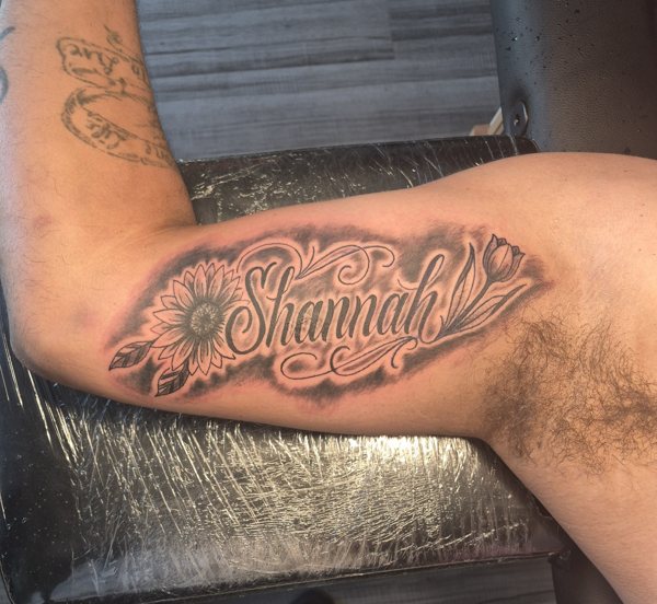Script and sunflowers tattoo